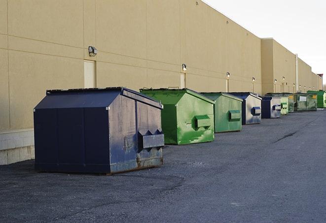 a series of colorful, utilitarian dumpsters deployed in a construction site in Barney, GA